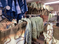 a room with a lot of clothes hanging on racks